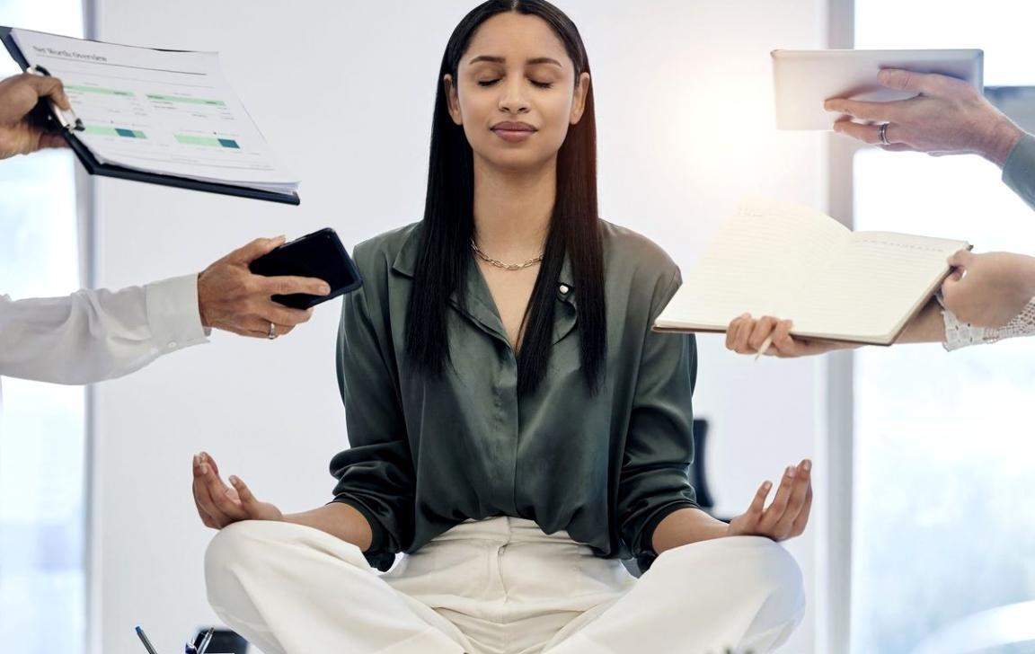 Student working on sound design project with headphones and audio software